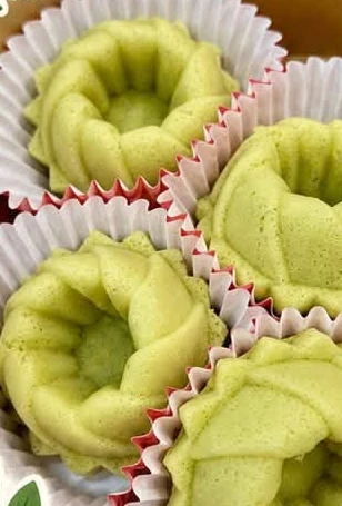 Steamed pandan cakes in paper cases.