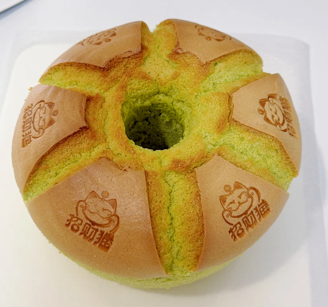Whole fresh pandan chiffon cake with the original lucky cat impressions, photographed by Chloe’s Mama Kitchen. Photograph does not identify a cake size.