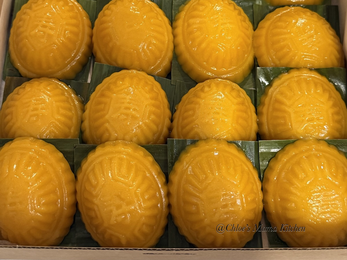 Pumpkin-skin Angku Kuih in a paper-lined box, with the original Chloe’s Mama Kitchen watermark retained. Batch photograph does not establish the selling quantity.